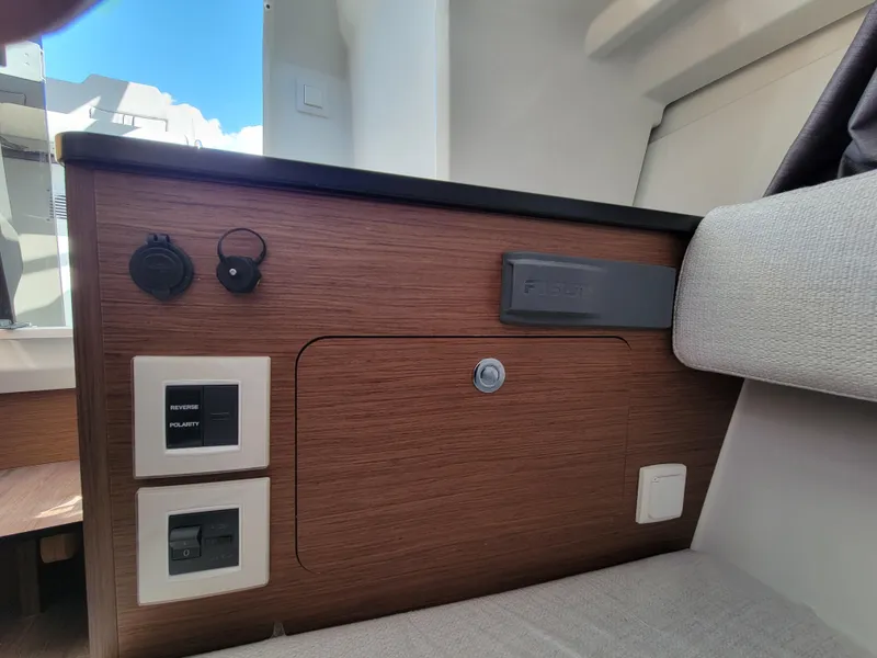 Slide: The Image of Interior cabin of 2024 Jeanneau Leader WA 7.5 boat with wooden paneling. - 17