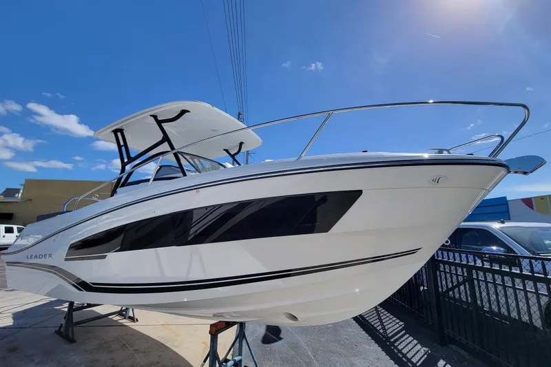 Slide: The Image of 2024 Jeanneau Leader WA 7.5 boat displayed outdoors under a clear blue sky. - 2
