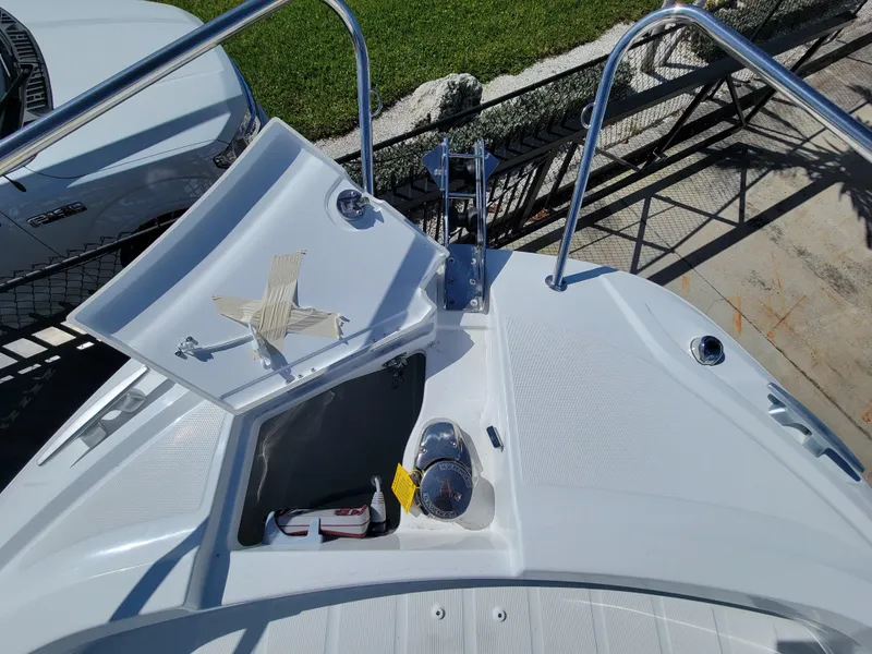 Slide: The Image of 2024 Jeanneau Leader WA 7.5 boat bow with anchor storage compartment open. - 23