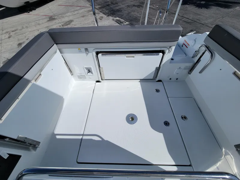 Slide: The Image of 2024 Jeanneau Leader WA 7.5 boat deck with storage compartments and seating. - 4