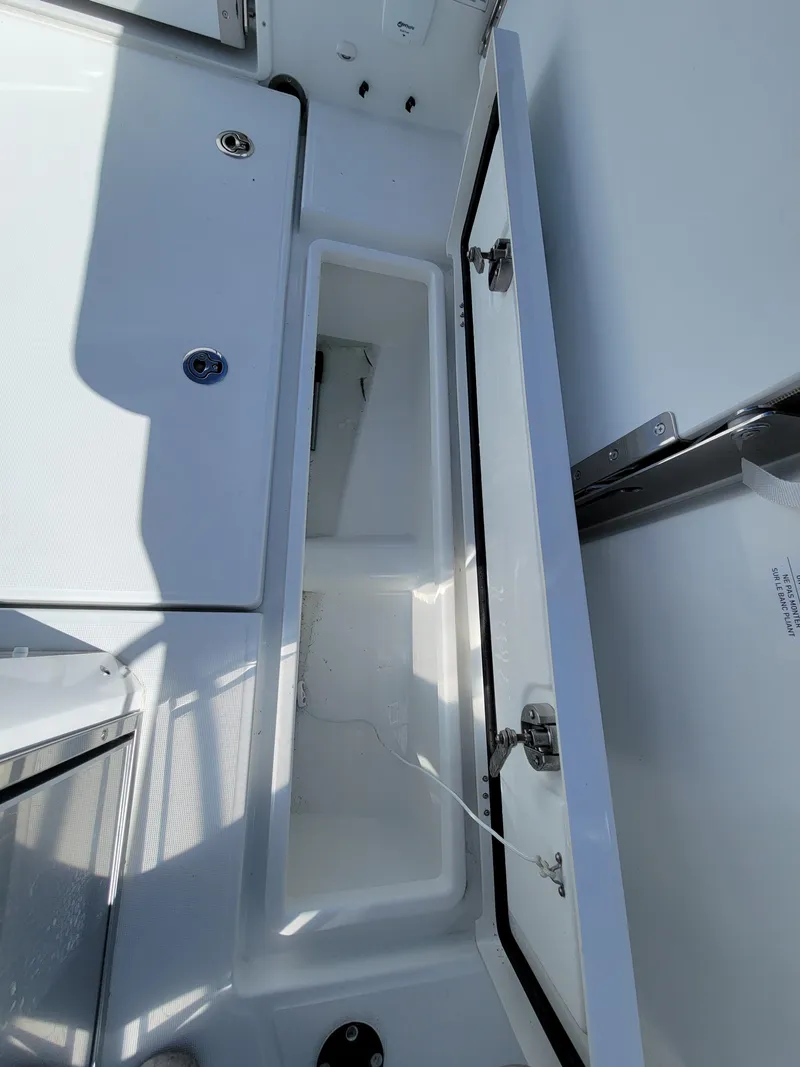Slide: The Image of 2024 Jeanneau Leader WA 7.5 boat storage compartment with open lid. - 6