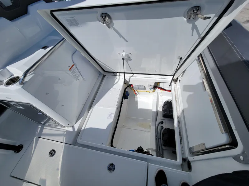 Slide: The Image of 2024 Jeanneau Leader WA 7.5 boat storage compartments open, showcasing interior space. - 7