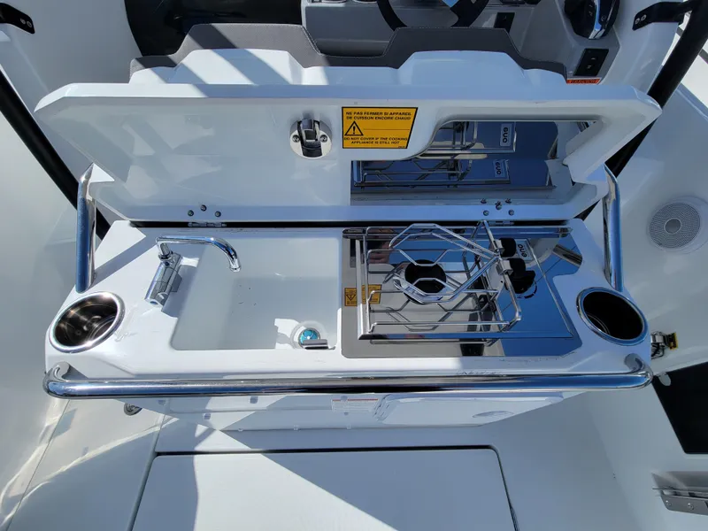 Slide: The Image of 2024 Jeanneau Leader WA 7.5 boat kitchen with sink and stove. - 8