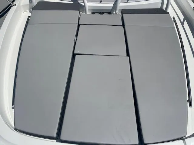 Slide: The Image of 2024 Jeanneau Leader 9.0 WA boat with cushioned sunbathing area. - 11