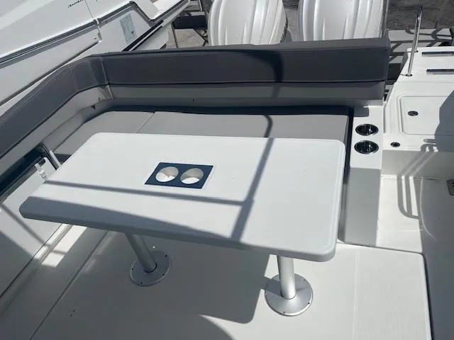Slide: The Image of 2024 Jeanneau Leader 9.0 WA boat interior with seating and table. - 19