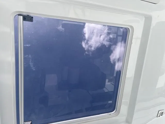 Slide: The Image of 2024 Jeanneau Leader 9.0 WA window with reflective glass and white frame. - 22