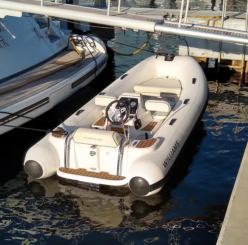 Slide: The Image of White Williams Turbojet tender docked beside a 1995 Mangusta motor yacht. - 37