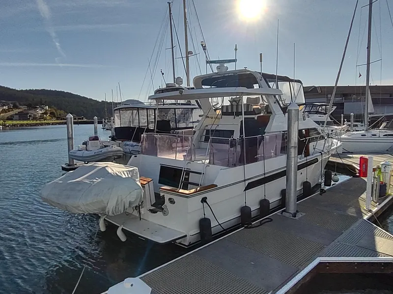 Slide: The Image of 1989 Ocean Alexander 440 CPMY yacht docked at marina under sunny sky. - 18
