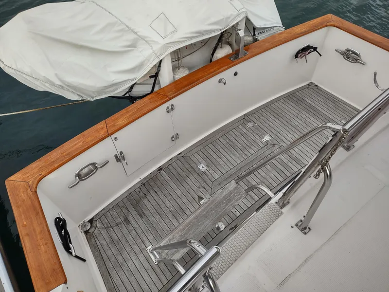 Slide: The Image of 1989 Ocean Alexander 440 CPMY boat deck with wooden trim and covered equipment. - 19