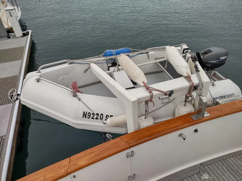 Slide: The Image of 1989 Ocean Alexander 440 CPMY with attached dinghy at dock. - 22