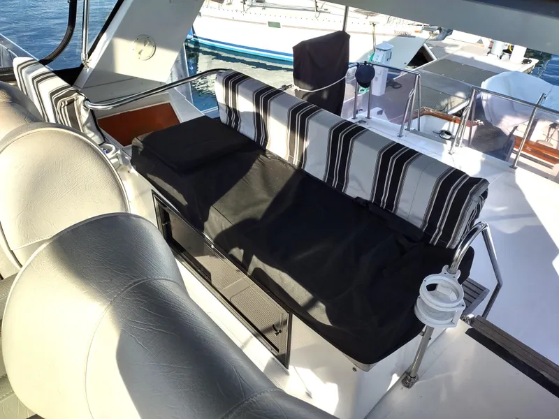 Slide: The Image of 1989 Ocean Alexander 440 CPMY boat interior with striped seating and helm station. - 38