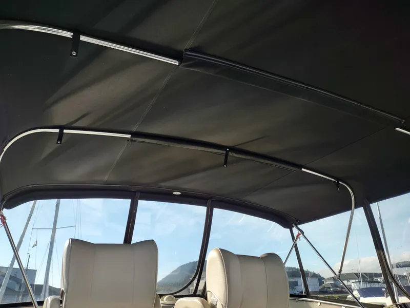 Slide: The Image of Interior view of 1989 Ocean Alexander 440 CPMY yacht with black canopy and white seats. - 41