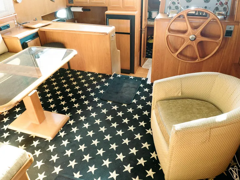 Slide: The Image of Interior of 1989 Ocean Alexander 440 CPMY yacht with star-patterned carpet and wooden furnishings. - 44