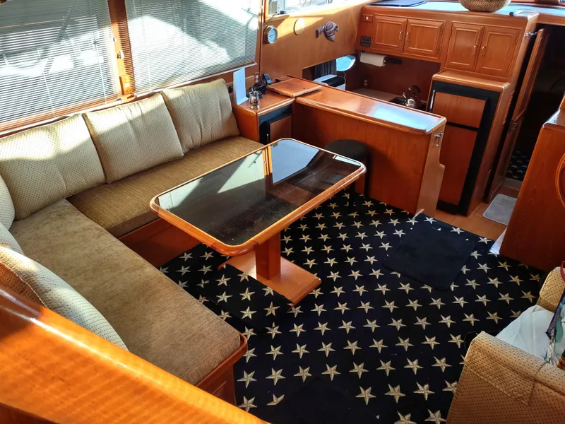 Slide: The Image of Luxurious 1989 Ocean Alexander 440 CPMY yacht interior with plush seating and star-patterned carpet. - 45