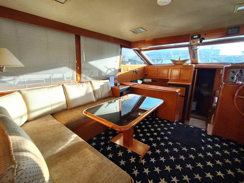 Slide: The Image of Interior of 1989 Ocean Alexander 440 CPMY yacht with cozy seating and star-patterned carpet. - 46