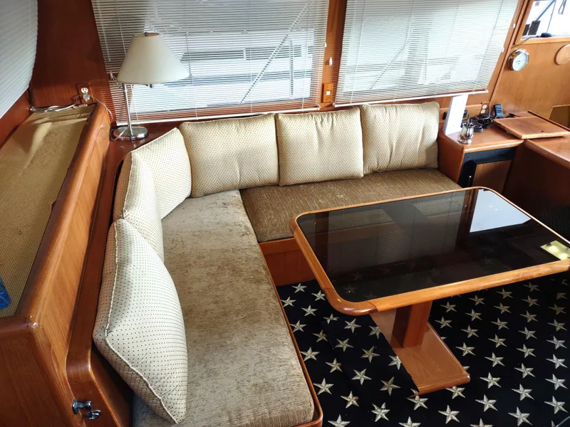 Slide: The Image of Luxurious 1989 Ocean Alexander 440 CPMY yacht interior with plush seating and elegant table. - 47