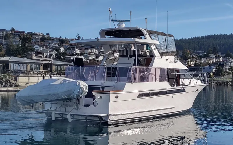 Slide: The Image of 1989 Ocean Alexander 440 CPMY yacht docked in a serene marina. - 8