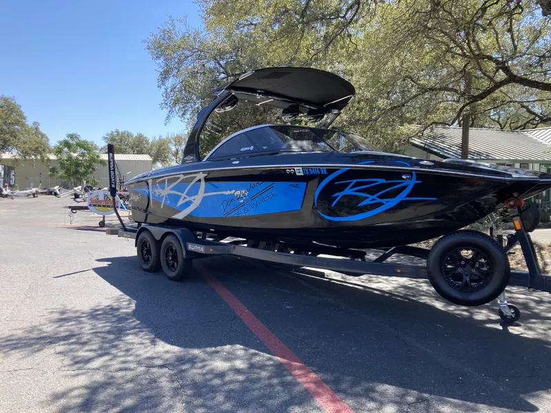 Slide: The Image of 2011 Tigé RZ2 boat on trailer in outdoor setting. - 10