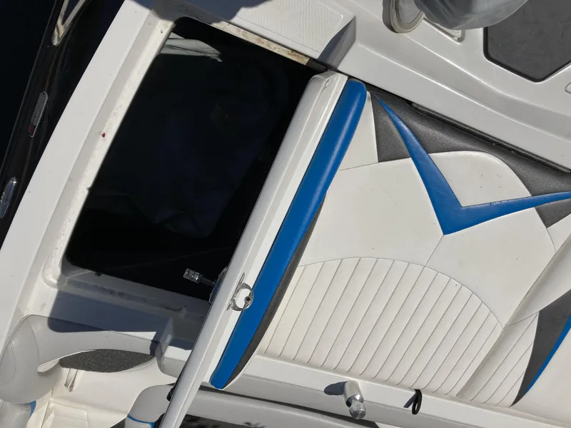 Slide: The Image of 2011 Tigé RZ2 boat interior with blue and white seating. - 12