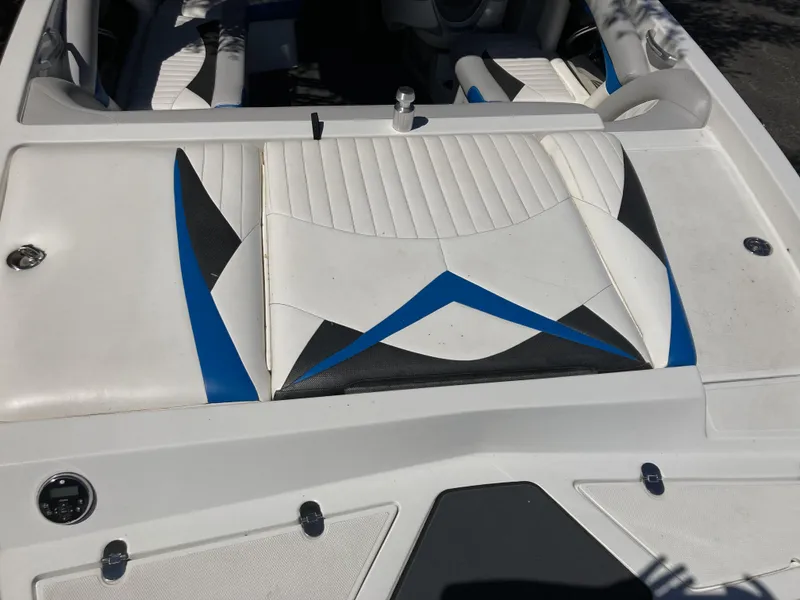 Slide: The Image of 2011 Tigé RZ2 boat interior with white, black, and blue upholstery. - 2