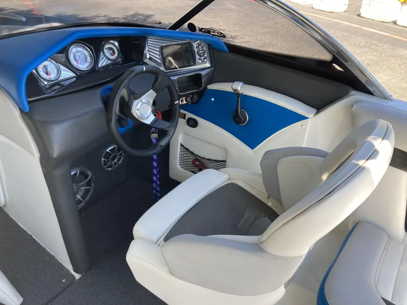 Slide: The Image of 2011 Tigé RZ2 boat interior with steering wheel, dashboard, and seating. - 4