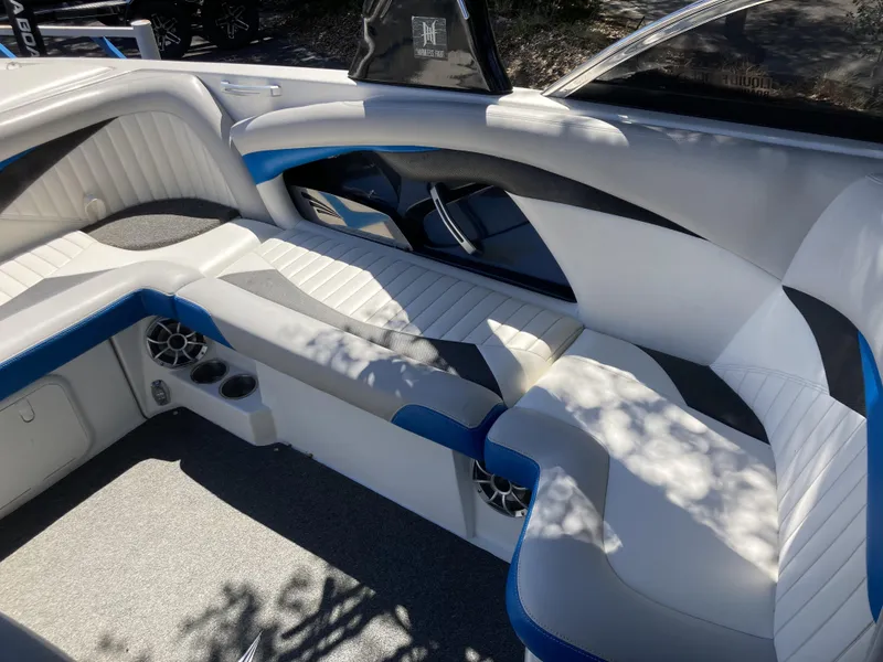 Slide: The Image of 2011 Tigé RZ2 boat interior with white, blue, and gray seating. - 5