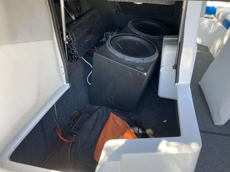 Slide: The Image of 2011 Tigé RZ2 boat interior with subwoofers and audio equipment. - 8