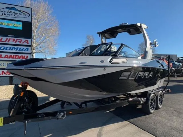 Slide: The Image of 2024 Supra SV 550 boat on trailer at Rocky Mountain Boat Co. dealership. - 1