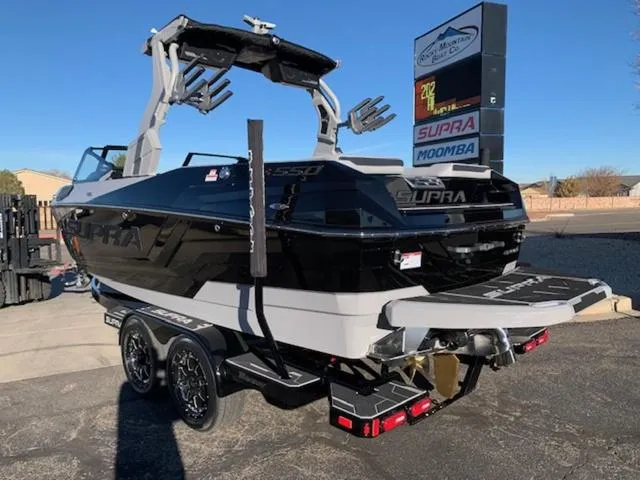 Slide: The Image of 2024 Supra SV 550 boat on a trailer, rear view, black and white color scheme. - 3