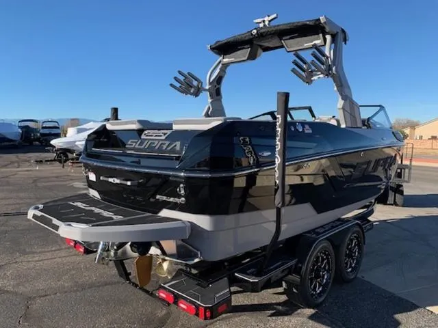 Slide: The Image of 2024 Supra SV 550 boat on a trailer, rear view, black and gray color. - 5