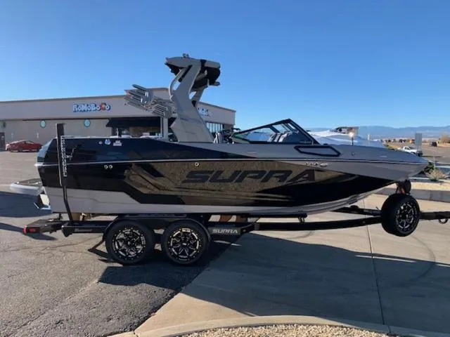 Slide: The Image of 2024 Supra SV 550 boat on a trailer in a parking lot. - 6