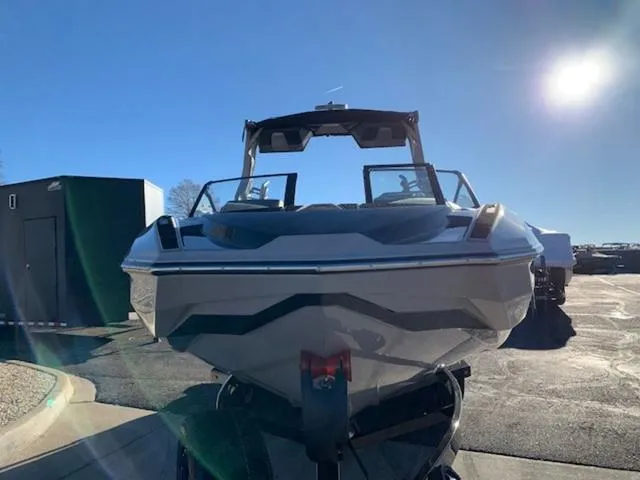 Slide: The Image of 2024 Supra SV 550 boat on a trailer under a clear blue sky. - 8