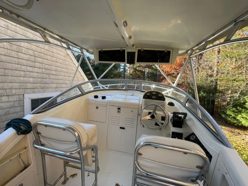 Slide: The Image of Interior view of 2003 Scout 280 Abaco boat cockpit with steering wheel and seating. - 12