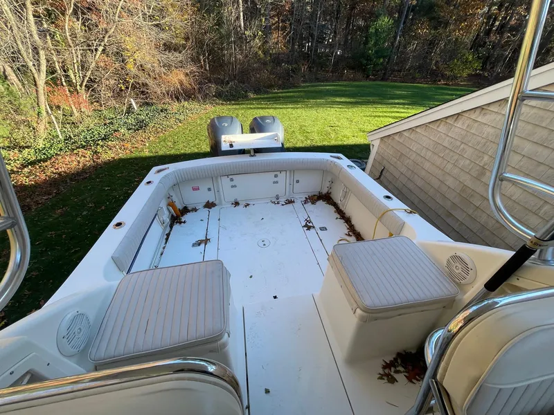 Slide: The Image of 2003 Scout 280 Abaco boat deck with seating, surrounded by autumn leaves. - 13