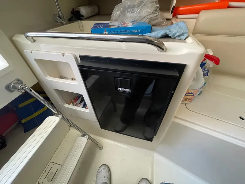 Slide: The Image of Interior of 2003 Scout 280 Abaco boat with mini fridge and storage compartments. - 24