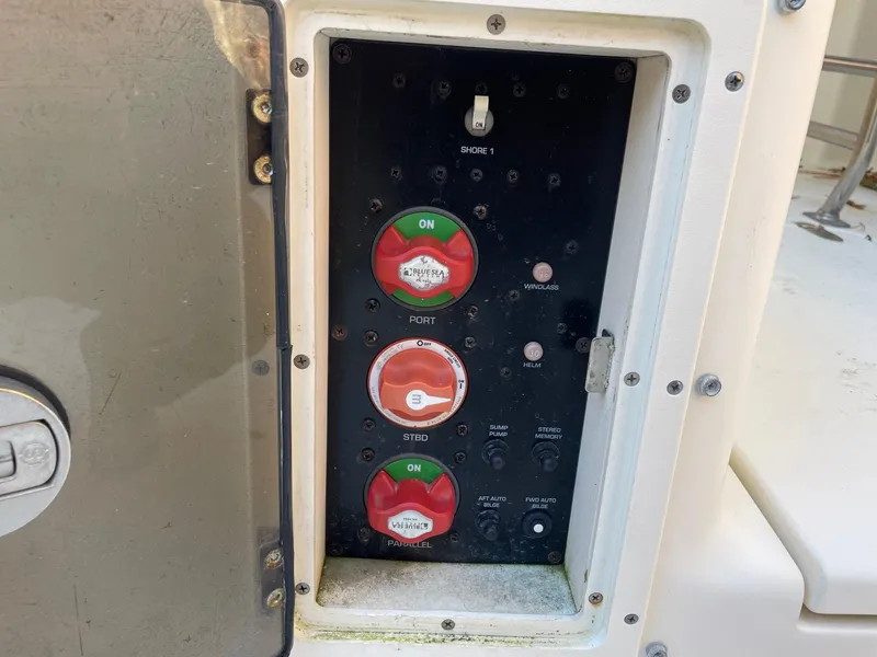 Slide: The Image of Control panel of a 2003 Scout 280 Abaco boat with switches and indicators. - 25