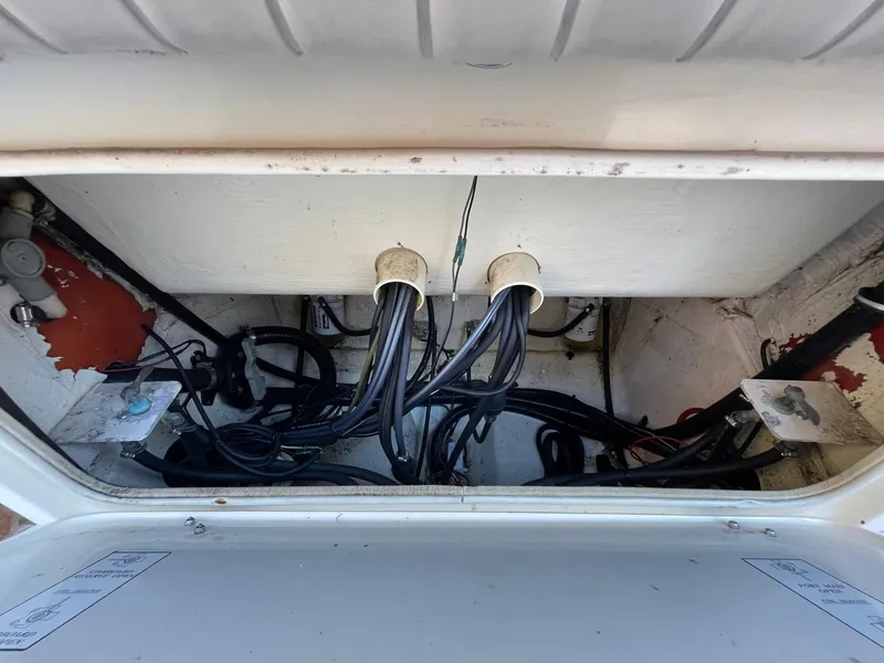 Slide: The Image of 2003 Scout 280 Abaco boat wiring compartment with cables and connections. - 26