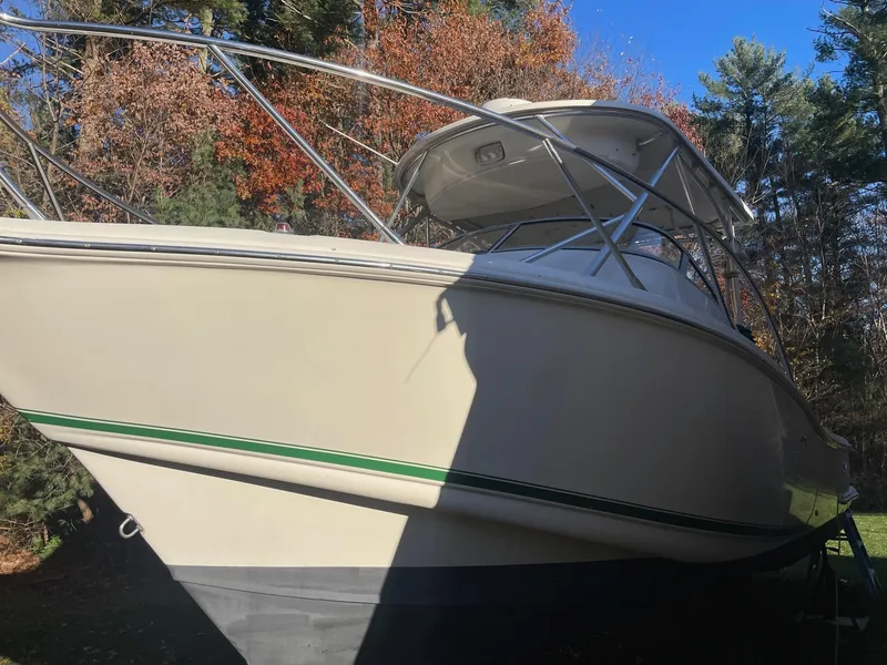 Slide: The Image of 2003 Scout 280 Abaco boat with sleek design, parked outdoors in autumn setting. - 27