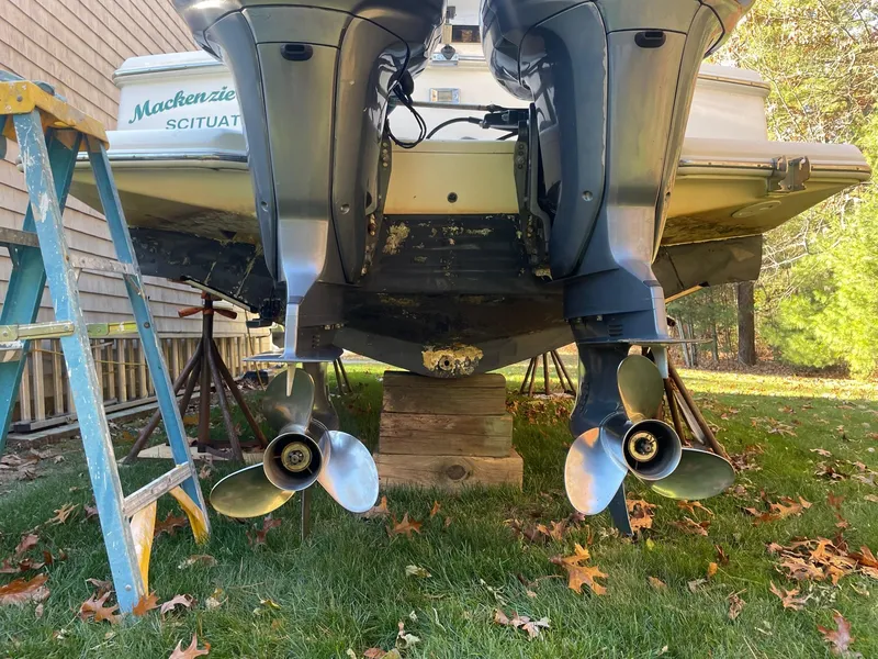 Slide: The Image of 2003 Scout 280 Abaco boat with dual outboard motors on grass. - 7