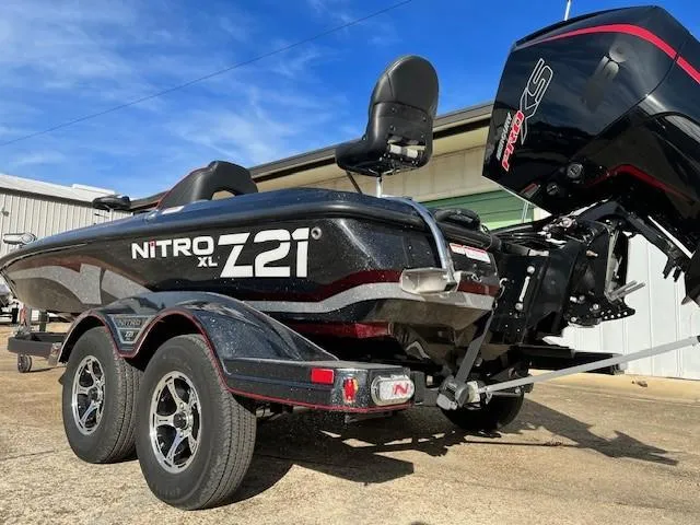 Slide: The Image of 2024 Nitro Z21 XL Pro bass boat with trailer and outboard motor. - 2