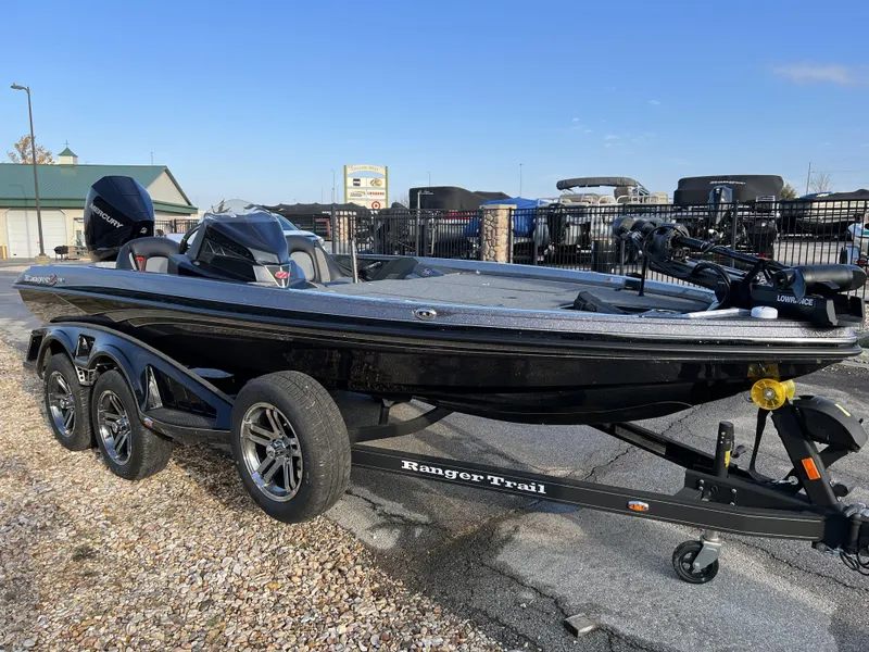 Slide: The Image of 2024 Ranger Z518 Ranger Cup Equipped boat on a trailer in a parking lot. - 3