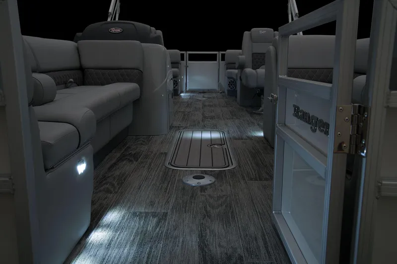 Slide: The Image of 2024 Ranger Reata 243C pontoon boat interior with ambient lighting and luxurious seating. - 20
