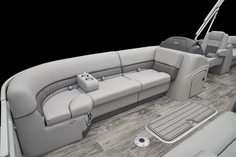 Slide: The Image of 2024 Ranger Reata 243C pontoon boat interior with gray seating and wood flooring. - 21