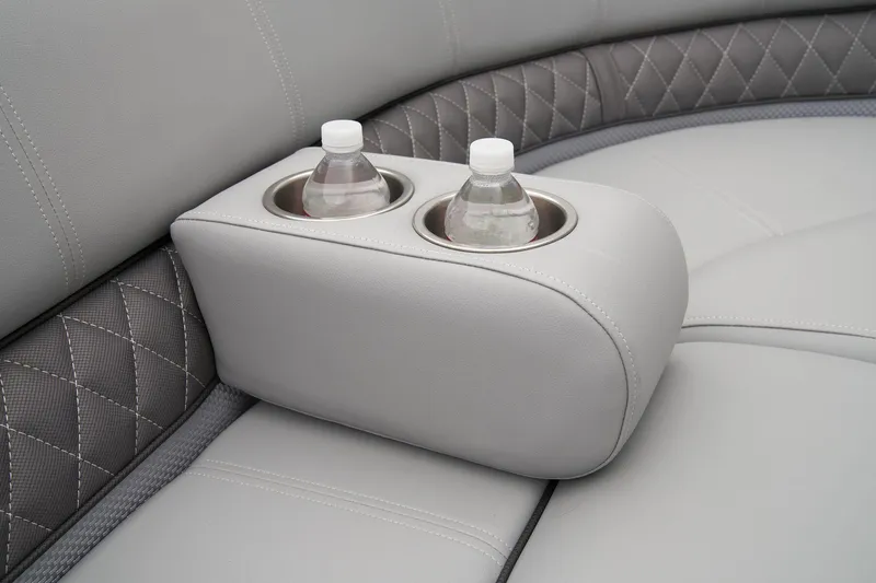 Slide: The Image of 2024 Ranger Reata 243C boat interior with cup holders and water bottles. - 24