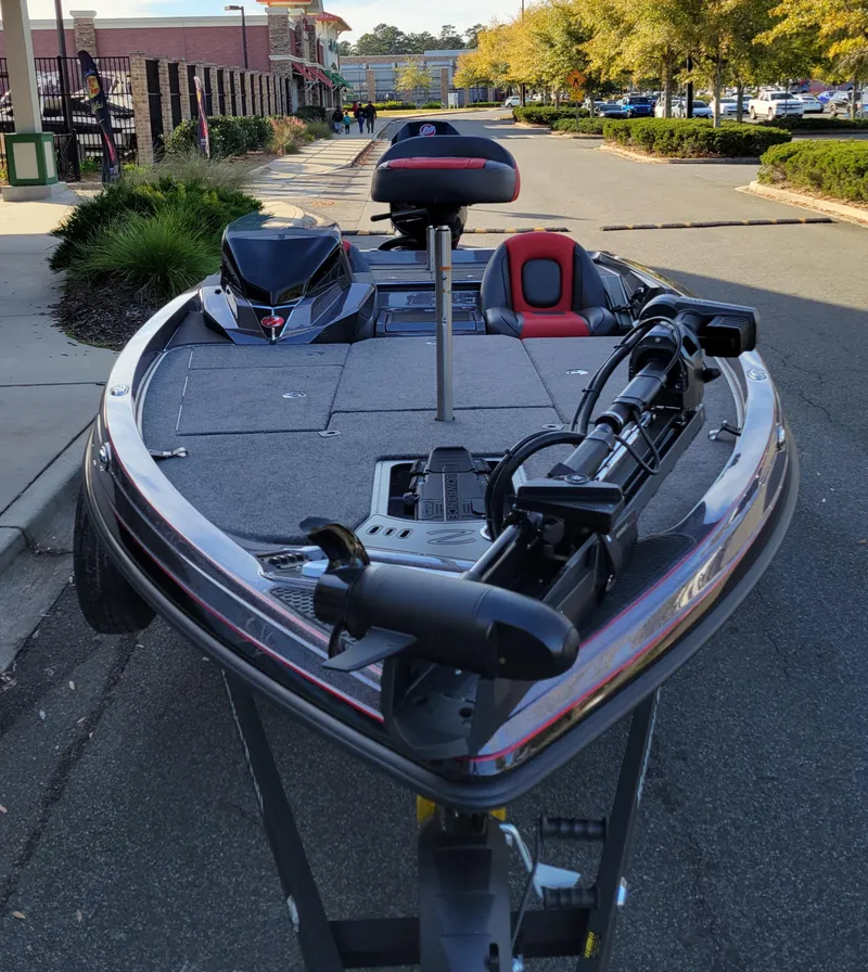 Slide: The Image of 2024 Ranger Z519 Ranger Cup Equipped bass boat parked on a street. - 2