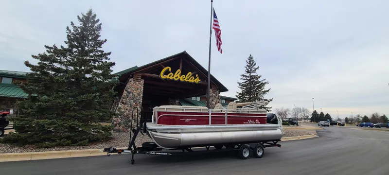 The Image of 2024 Sun Tracker Party Barge 22 XP3 pontoon boat outside Cabela's store. - 0