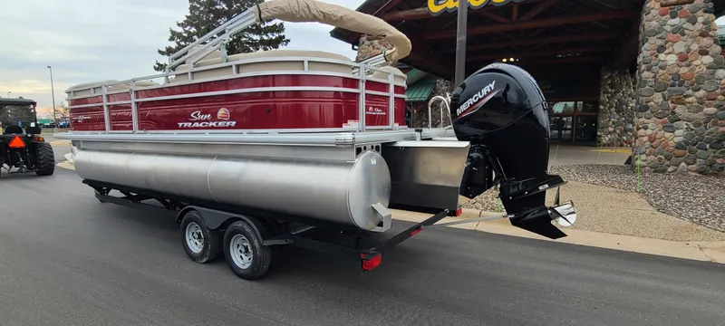 Slide: The Image of 2024 Sun Tracker Party Barge 22 XP3 pontoon boat on trailer, rear view. - 3