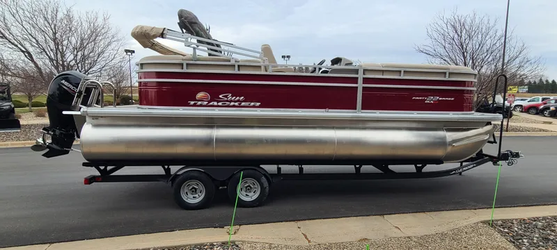 Slide: The Image of 2024 Sun Tracker Party Barge 22 XP3 pontoon boat on trailer, side view. - 5