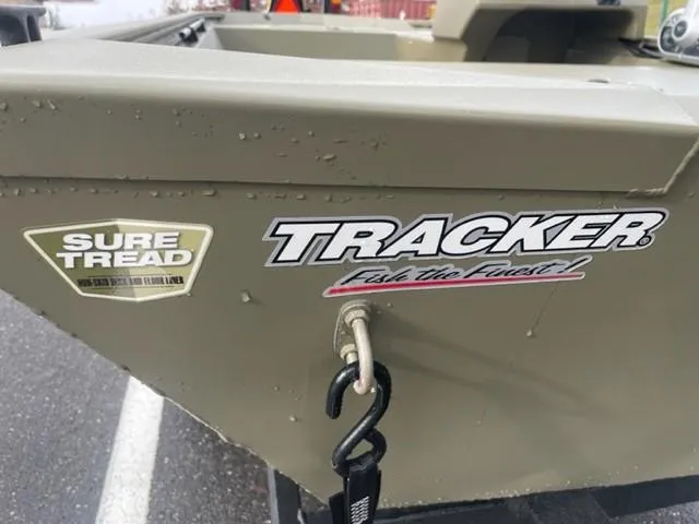 Slide: The Image of 2024 Tracker Grizzly 1648 SC boat with Sure Tread logo. - 2