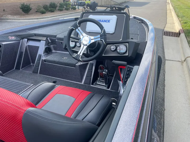 Slide: The Image of 2024 Ranger Z519 boat interior with steering wheel and red-black seats. - 4